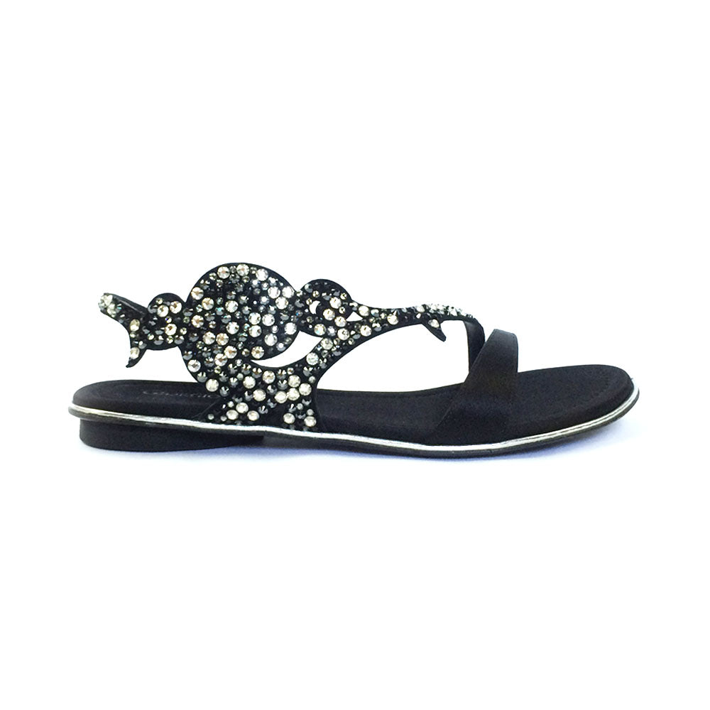 A black flat sandal with a decorative satin lining and sparkling elements on the straps, handmade in Italy.
