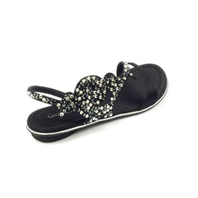 A black flat sandal with a decorative satin lining and sparkling elements on the straps, handmade in Italy.