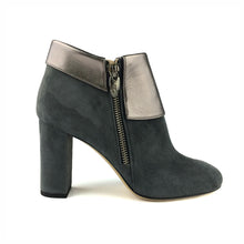 A suede ankle boot with a metallic finish and zipper on the side, featuring a chunky heel.
